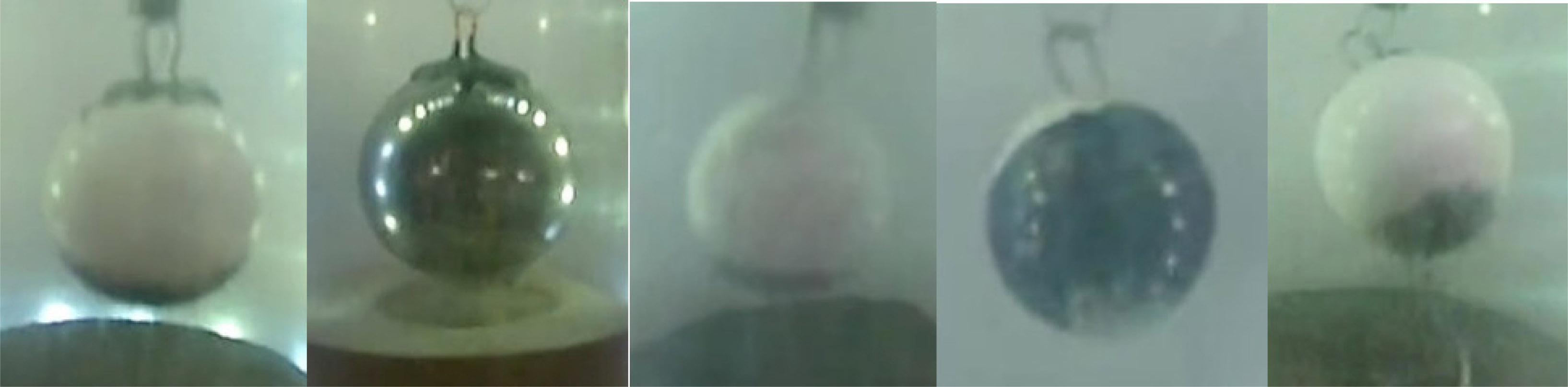 Observations of mass transfer from regolith onto cm-size marble in a free-fall, vacuum environment.