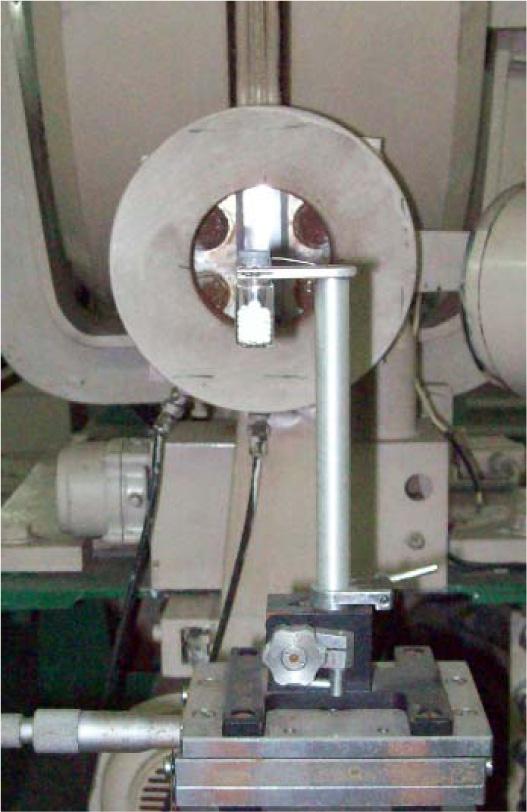 LAE 13/9 electron accelerator in the setting for direct beam irradiation. Bottle with a PP sample on the background of the accelerator window.