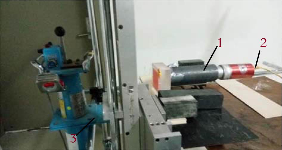 Experimental setup from left showing the Am-241 in the blue containment shield, the ACR phantom placed in the mechanical arm surrounded with lead blocks to stabilize the arm movement, and finally is the NaI detector with a lead sleeve to shield it from the scattered radiation. 1 – ACR phantom, 2 – NaI crystal, 3 – Am-241 source.