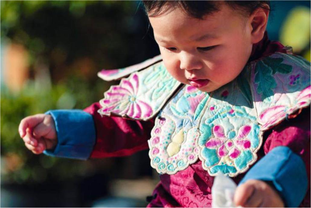 A baby wearing embroidery bib