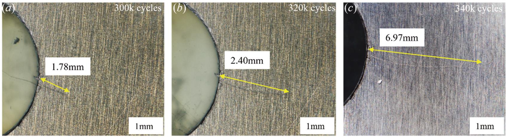 Optical microscope images of fatigue crack ar at: (a) 300k cycles, (b) 320k cycles, (c) 340k cycles.